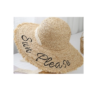Detailed straw sun hat with black Sun Please embroidery and white lace ribbon