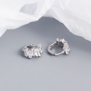Macro shot of silver sterling earrings featuring rectangular clear zircon crystals