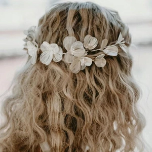 Handmade bridal gold flower headband and earring set shown on model with elegant hairstyle