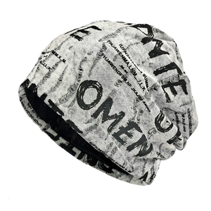 Distressed knit beanie with letter print and fringe edges in street style style