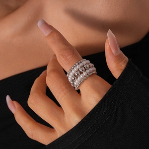 Close-up of multilayered beaded ring with white pearls and silver metal beads for women