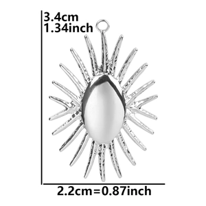 Detail view of a silver sunburst pendant showing 3.4cm by 2.2cm size measurements