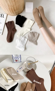 Detailed close-up of ribbed texture and elastic cuff on multi-color cotton socks