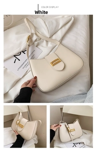 Detail view of cream saddle shoulder bag with golden buckle and adjustable strap