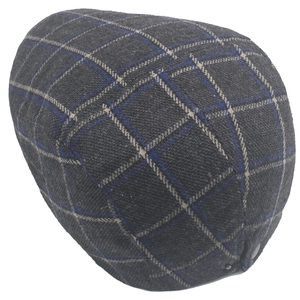 Detail of dark grey plaid flat cap with adjustable buckle and wool knit texture