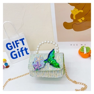 Detail of sequin mermaid purse featuring green fish tail and purple starfish patches