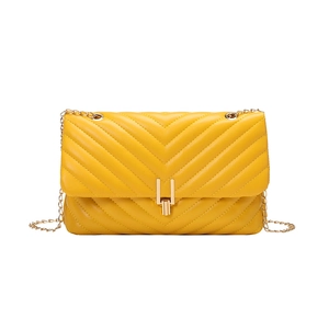 Yellow faux leather crossbody bag with V-shaped quilting and a gold metal chain strap