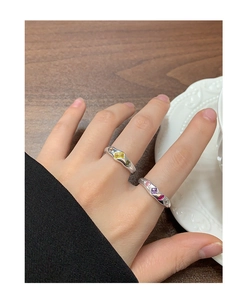 Detail of silver S925 rings featuring geometric micro-pave colored zircon stones