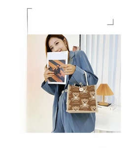 Close-up of cute cartoon bear print tote bag with cotton rope handles and button closure