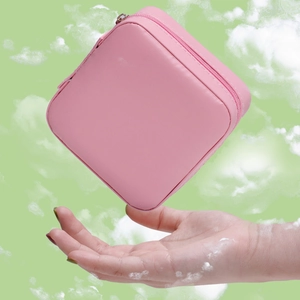 Pink PU leather square travel jewelry box for necklaces and earrings shown floating