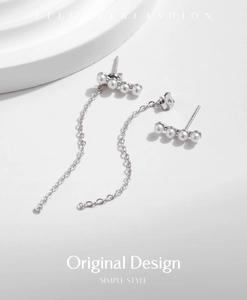 Macro shot of 925 silver long fringe tassel earrings with delicate white pearls