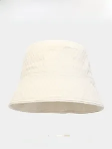 Detail of a beige bubble-textured bucket hat fabric showing high-quality woven craftsmanship