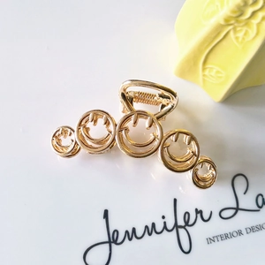Golden metal hair claw clip with five hollow smiley face designs for women hair styling