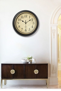 Close-up of retro silent wall clock featuring black and gold frame with quartz movement