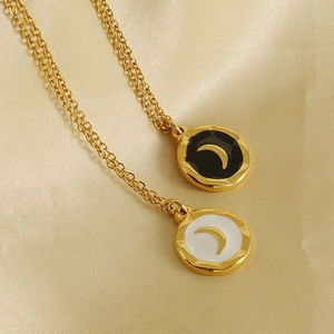 18K gold plated stainless steel crescent moon pendant necklace on silk backdrop