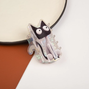 Close-up of cute cartoon cat hair claw clip made of iridescent black and white acetate