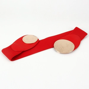 Detail of red elastic waist belt featuring dual oversized gold circular metal buckles