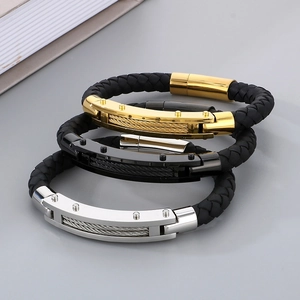 Close-up of woven leather bracelets for men with gold, black, and silver metal accents