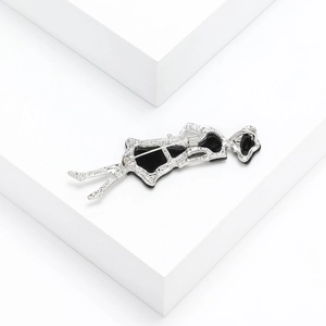 Detailed back view of silver alloy girl profile brooch with black inlay and pin fastener