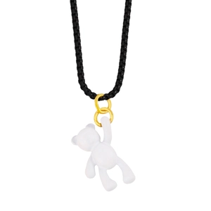 Detailed close-up of white 3D bear pendant on black woven cord necklace with gold links
