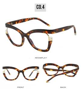 Detail of tortoise cat-eye glasses frame featuring elegant white pearl accents and cutouts