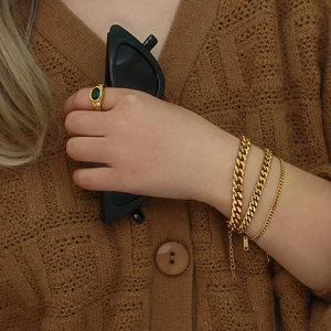 18K gold plated Cuban link bracelets and green gemstone ring set on female model
