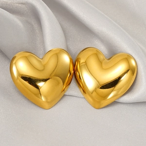 Polished 18K gold heart-shaped stainless steel stud earrings on silver silk background