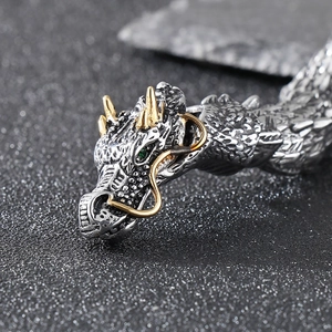 Punk style dragon bracelet in stainless steel with gold horns and green eyes