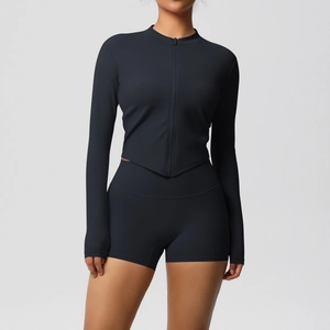 Close-up of black two-piece sports set with slim-fit zip jacket and high-waist yoga shorts