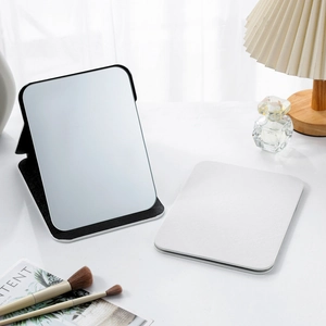 Foldable desktop makeup mirror with white PU leather cover shown in open and closed views