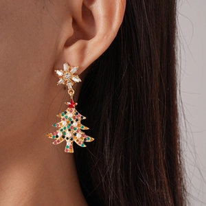 Close-up of snowflake and Christmas tree earrings with colorful crystals and pearls