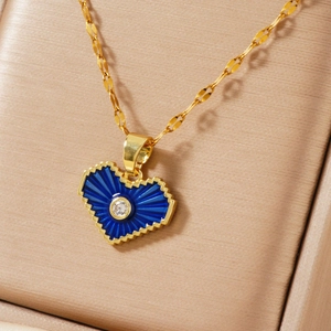 Blue heart pendant necklace with gold pixelated edge in a luxury jewelry gift box
