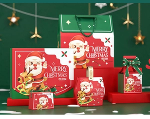 Detailed view of red and green Christmas gift boxes with festive gold ribbon handles