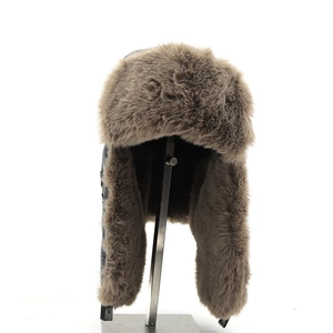 Detail of grey winter trapper hat showing thick brown faux fur lining on inner ear flaps