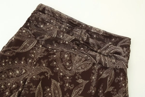 Détails d'une jupe taille haute à motif cachemire marron avec des plis travaillés