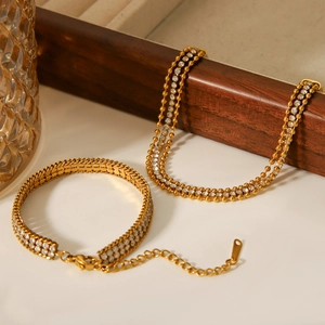 Detail of 18K gold-plated bracelets featuring double-row zircons and round bead chains