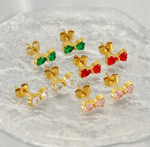 Close-up of heart-cut cubic zirconia bow earrings in green, red, white, and pink sets