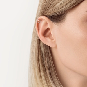 Close-up of minimalist double-layer silver ear cuff worn on the upper ear cartilage