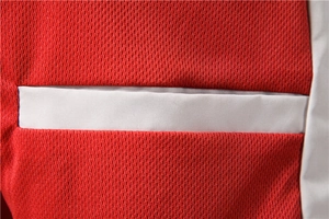 Detail view of red breathable mesh fabric with white horizontal stitching on a men's jacket