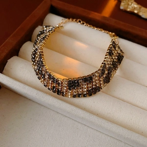 Macro shot of rhinestone leopard pattern bracelet in a velvet box with adjustable clasp