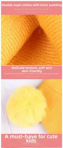 Detail of orange knitted baby hat showing double-layer cotton fabric and fluffy faux fur pompom