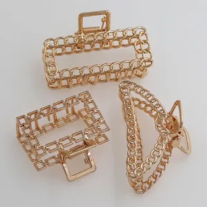 Three geometric gold alloy hair claws including square and chain link rectangle designs