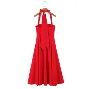 Detail of red halter dress featuring a large elegant bow tie on the open back design