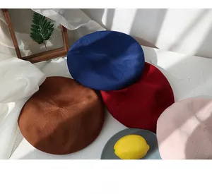 Flat lay detail showing a collection of colorful knitted berets in diverse candy colors