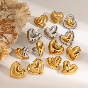 Golden and silver heart-shaped stainless steel earrings on a clean white background