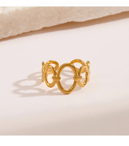 Detailed view of an 18K gold plated oval hollow ring on a textured stone display