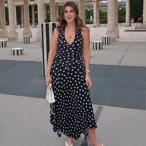 Chic backless polka dot halter maxi dress showing flowing fabric and elegant style