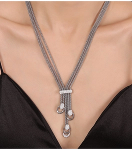 Close-up of a silver multi-layer tassel necklace with sparkling diamond pendant