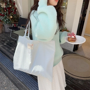 Striped canvas tote bag in mint green and white for daily commuting and school