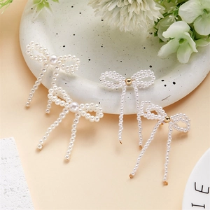 Elegant white pearl bow earrings with long tassels and gold metal accents for women